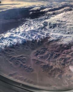 Plane window seat view of Jordan Mountains shot on iPhone