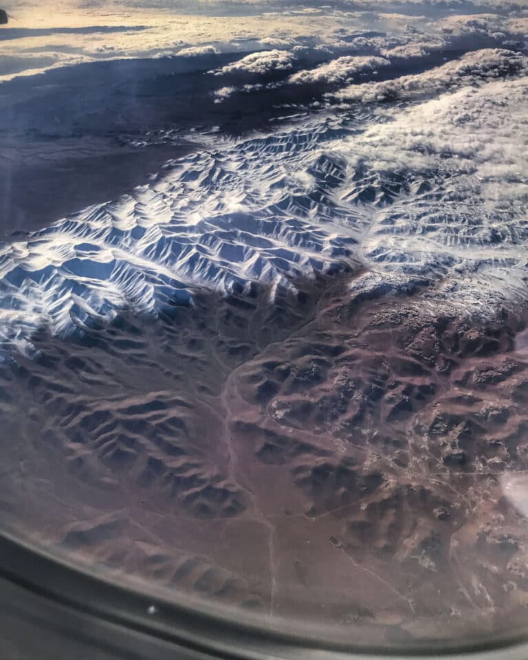 Plane window seat view of Jordan Mountains shot on iPhone